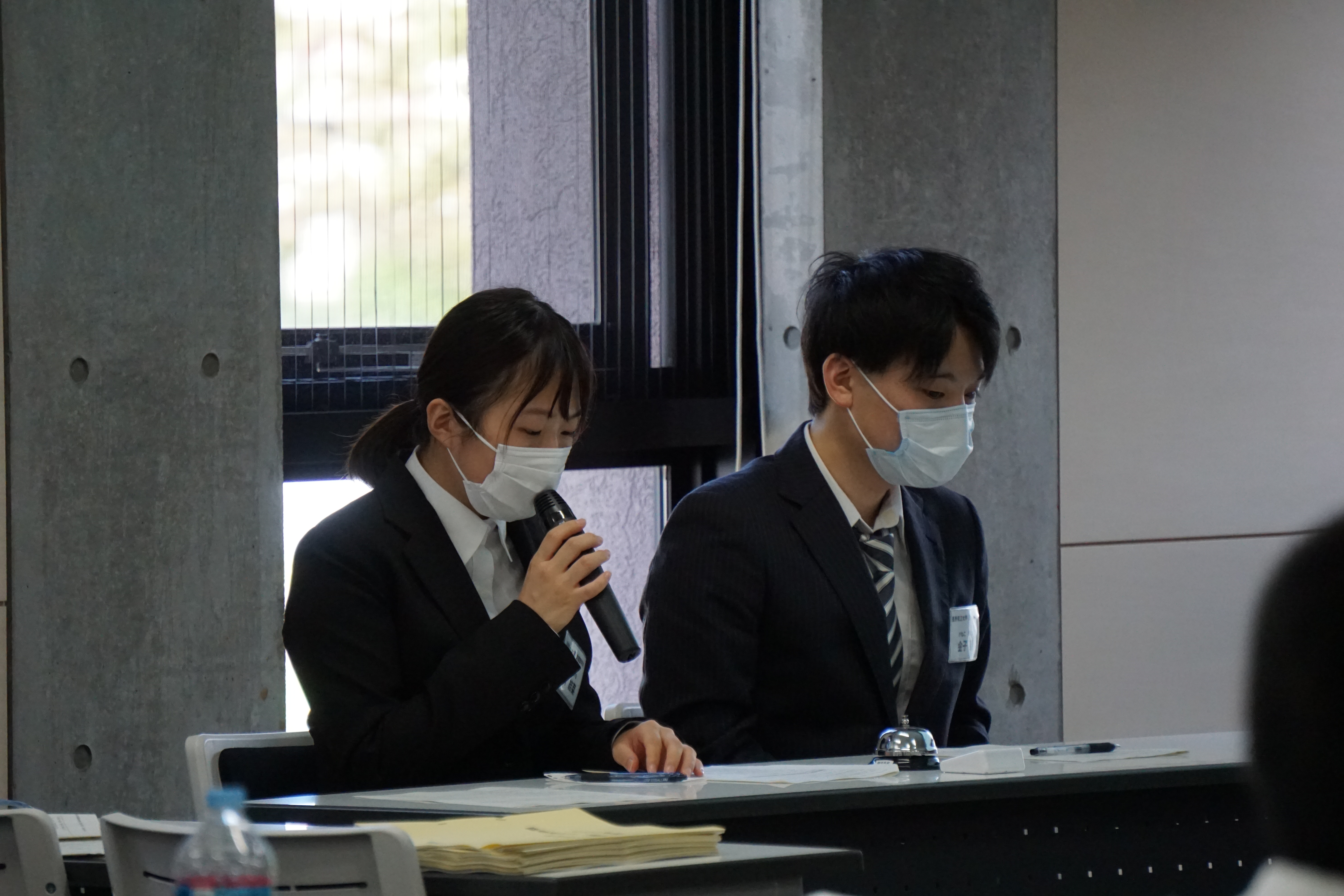 報告会の進行をする学生司会者